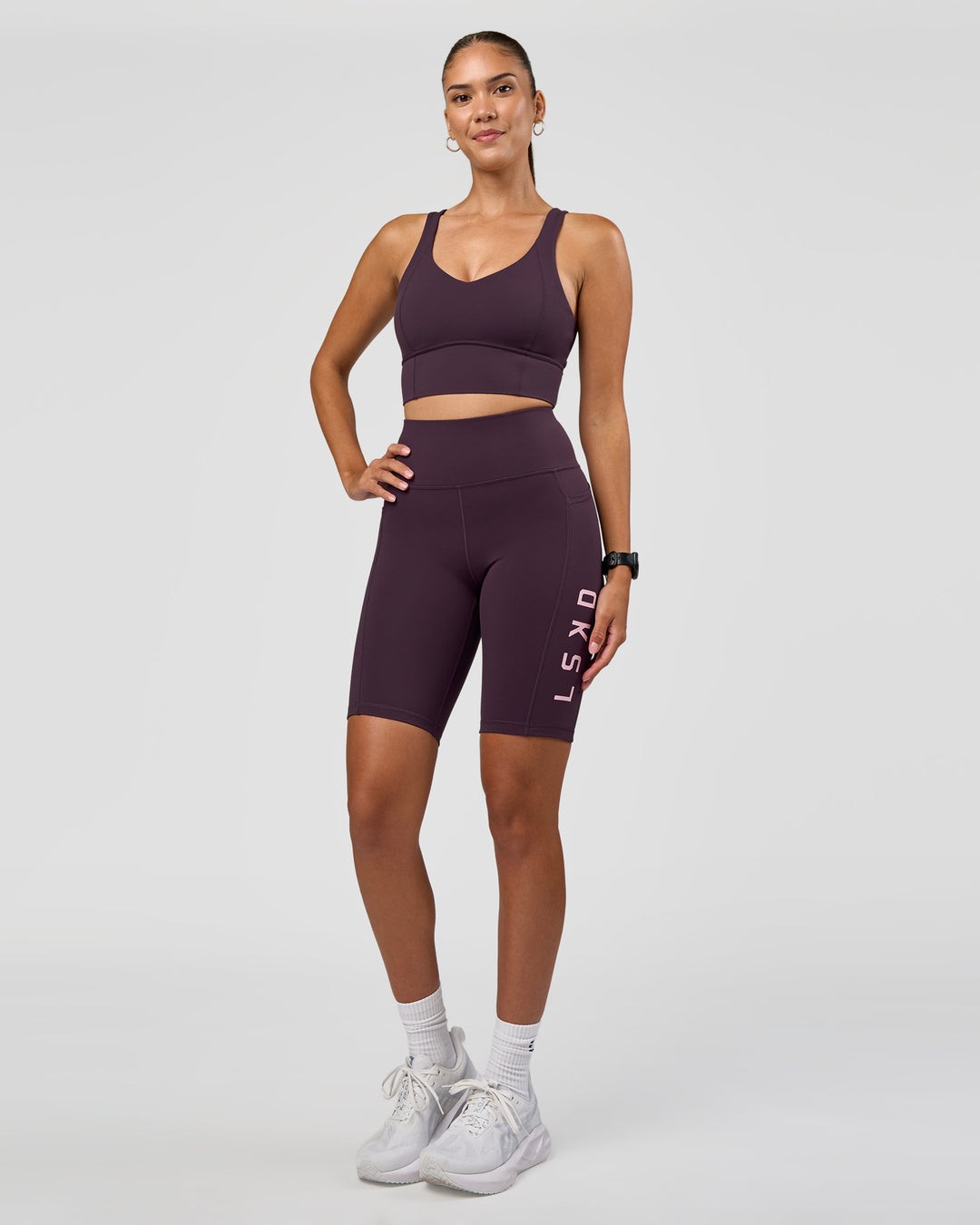 Woman wearing Rep Ultra High-Rise 9" Short Pockets - Midnight Plum-Marshmallow | Model:Rhiley | Size:S