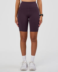 Woman wearing Rep Ultra High-Rise 9" Short Pockets - Midnight Plum-Marshmallow | Model:Rhiley | Size:S