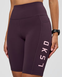 Woman wearing Rep Ultra High-Rise 9" Short Pockets - Midnight Plum-Marshmallow | Model:Rhiley | Size:S