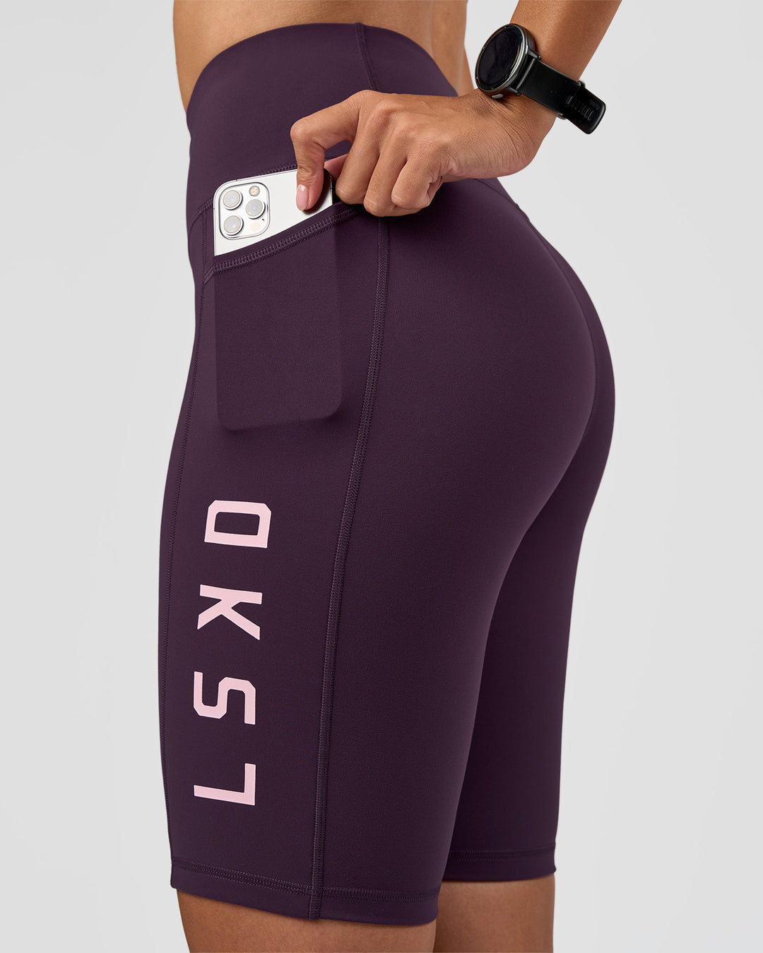 Woman wearing Rep Ultra High-Rise 9" Short Pockets - Midnight Plum-Marshmallow | Model:Rhiley | Size:S