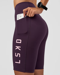 Woman wearing Rep Ultra High-Rise 9" Short Pockets - Midnight Plum-Marshmallow | Model:Rhiley | Size:S