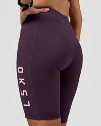 Woman wearing Rep Ultra High-Rise 9" Short Pockets - Midnight Plum-Marshmallow | Model:Rhiley | Size:S