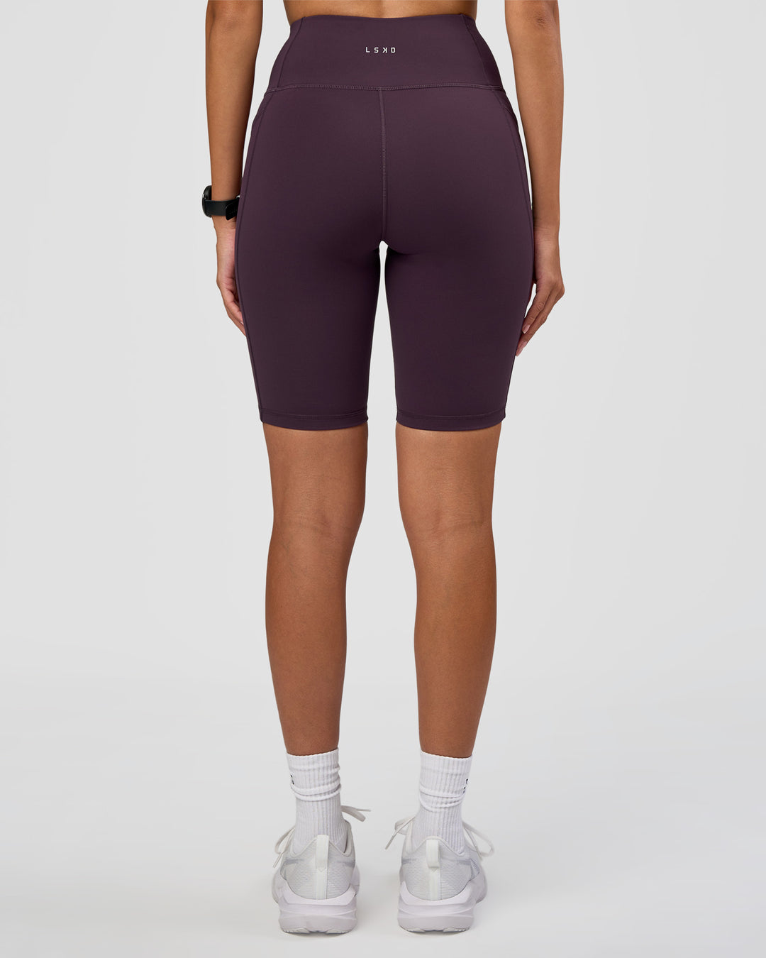 Woman wearing Rep Ultra High-Rise 9" Short Pockets - Midnight Plum-Marshmallow | Model:Rhiley | Size:S