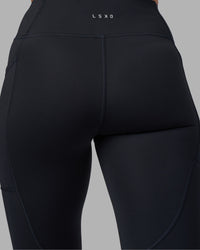 Woman wearing Rep Ultra High-Rise Full Length Legging Pockets - Black-Blue Atoll | Model:Sophie | Size:S