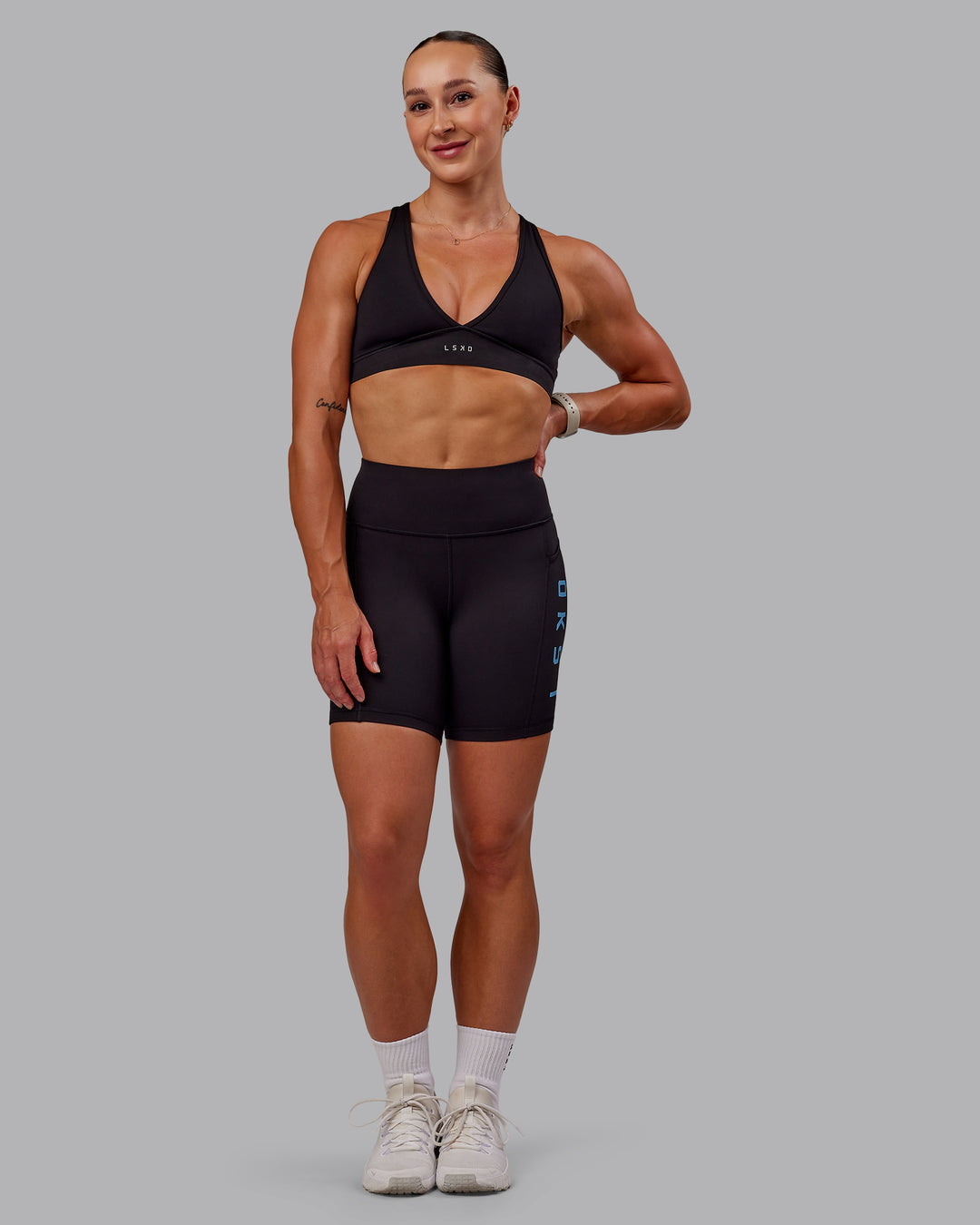Woman wearing Rep Ultra High-Rise 6&quot; Short Pockets - Black-Azure Blue | Model:Amber | Size:S