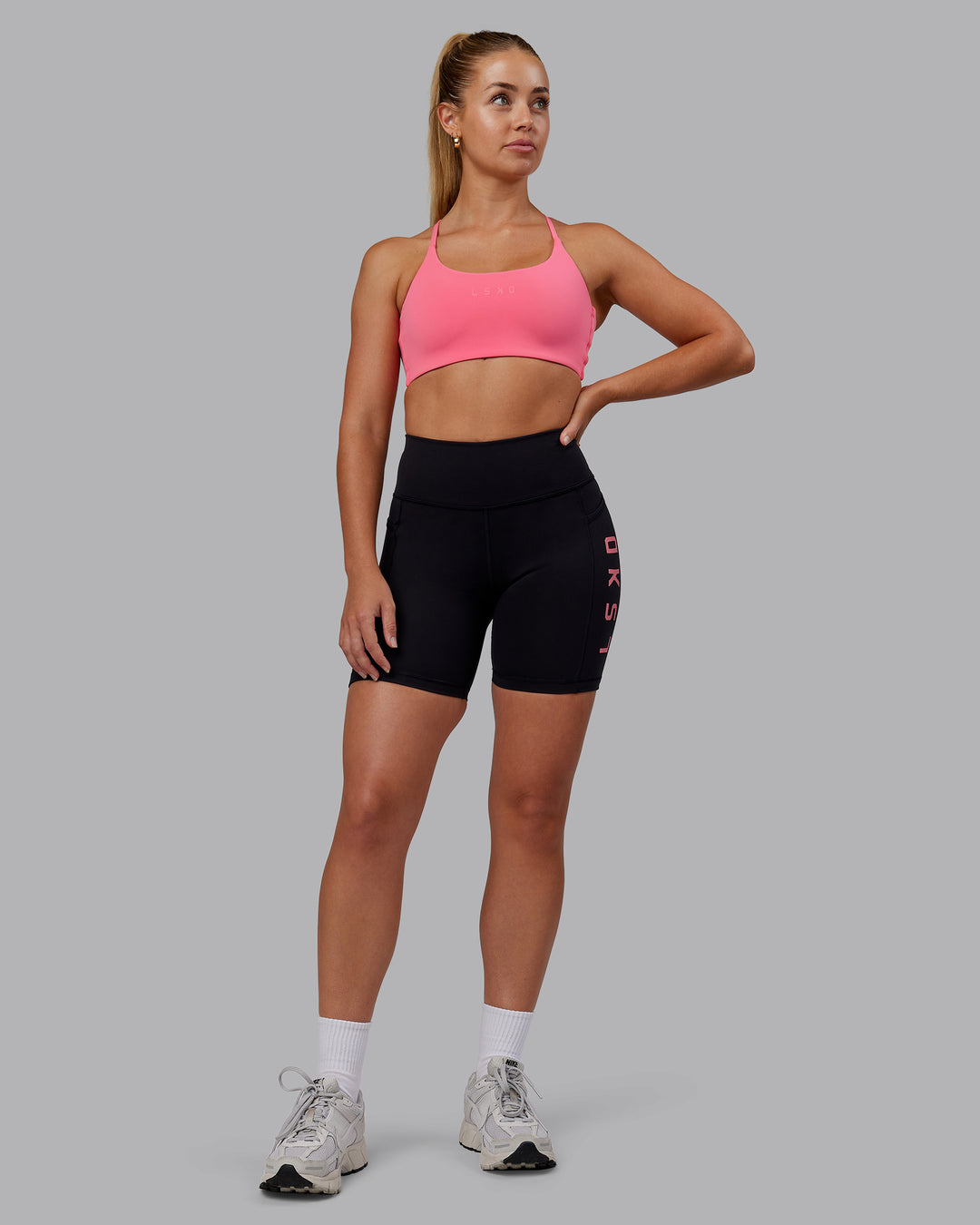 Woman wearing Rep Ultra High-Rise 6&quot; Short Pockets - Black-Pink Lemonade | Model:Hannah | Size:S
