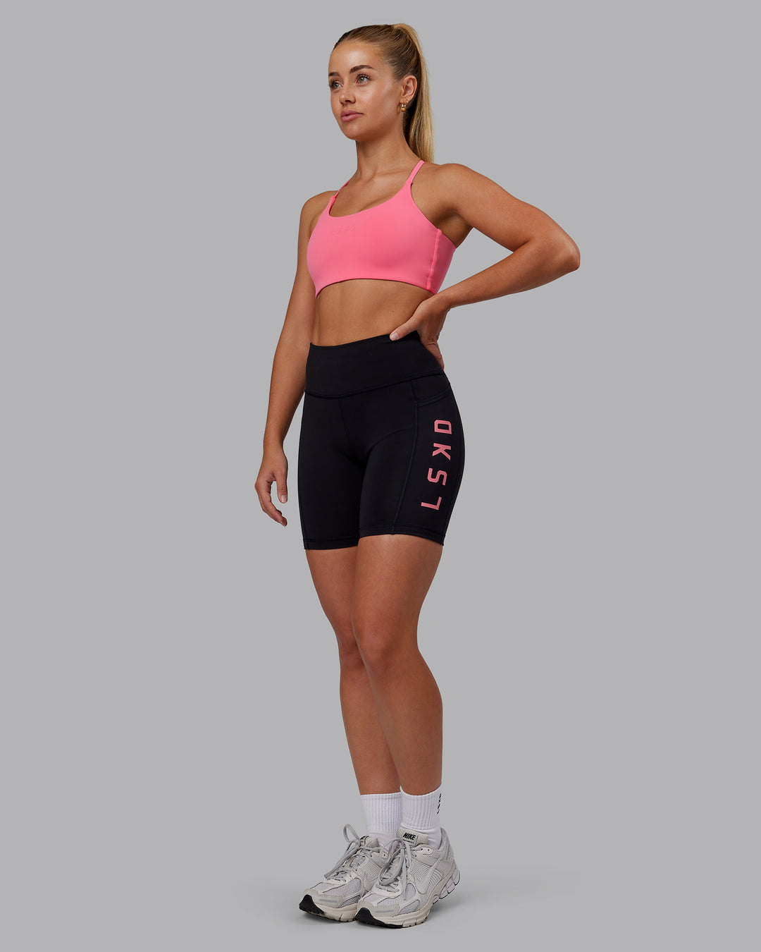 Woman wearing Rep Ultra High-Rise 6&quot; Short Pockets - Black-Pink Lemonade | Model:Hannah | Size:S