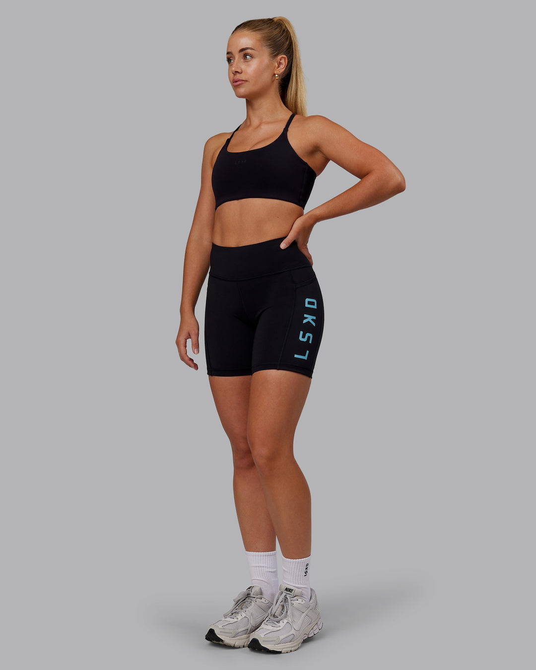 Woman wearing Rep Ultra High-Rise 6&quot; Short Pockets - Black-Retro Blue | Model:Hannah | Size:S