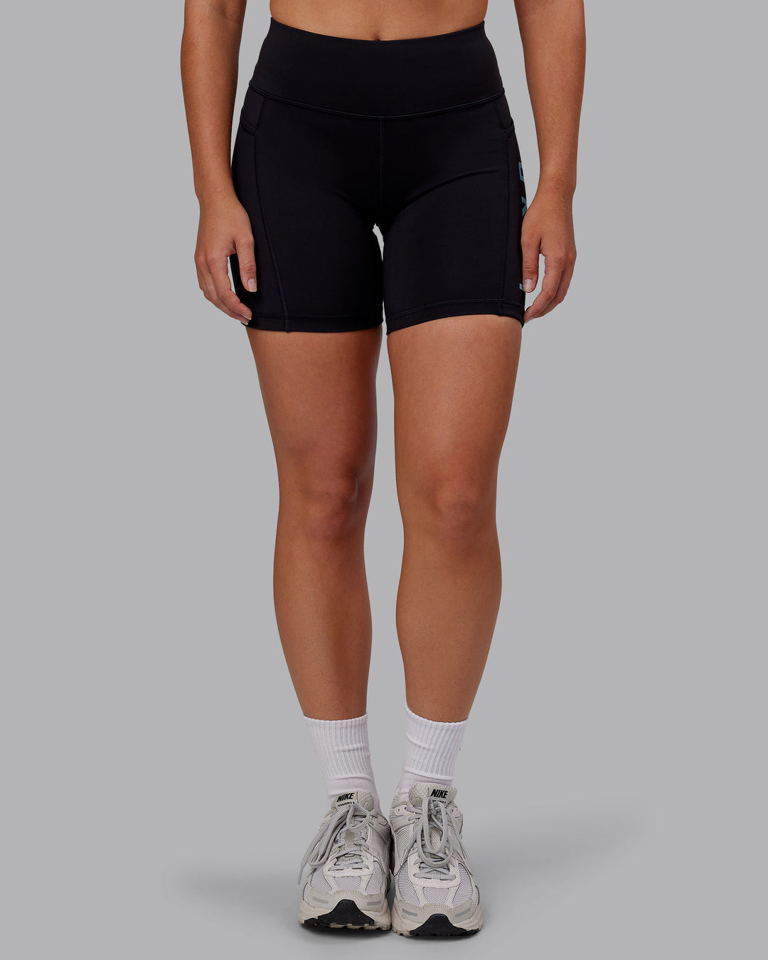 Woman wearing Rep Ultra High-Rise 6&quot; Short Pockets - Black-Retro Blue | Model:Hannah | Size:S