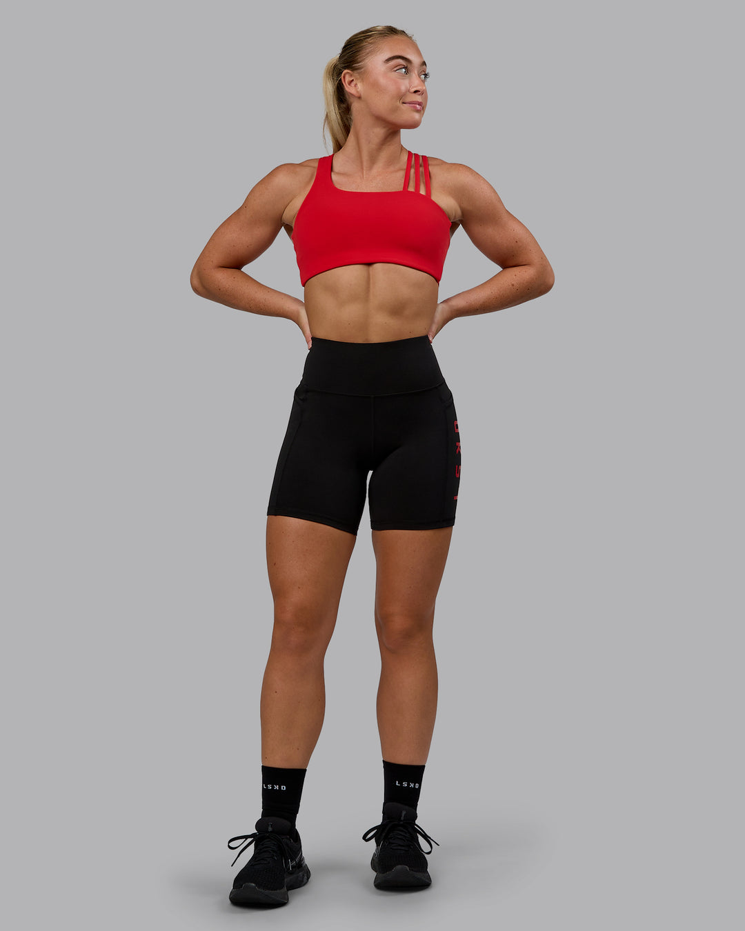 Woman wearing Rep Ultra High-Rise 6&quot; Short Pockets - Black-Crimson | Model:Monique | Size:S