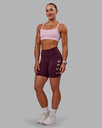Woman wearing Rep Ultra High-Rise 6" Short Pockets - Cherry Lacquer-Marshmallow | Model:Amber | Size:S