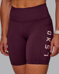 Woman wearing Rep Ultra High-Rise 6" Short Pockets - Cherry Lacquer-Marshmallow | Model:Amber | Size:S