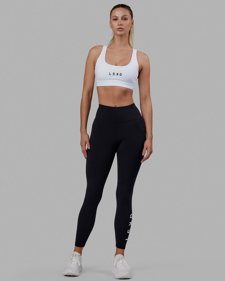 Woman wearing Rep Sports Bra Small Logo - White-Black