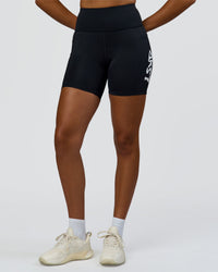 Woman wearing Rep Street Script Ultra High-Rise 6" Short Pockets - Black-White | Model:Rosie | Size:S