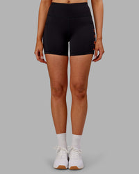 Woman wearing Rep Ultra High-Rise 4" Short Pockets - Black-Ultra Orange | Model:Ella | Size:S
