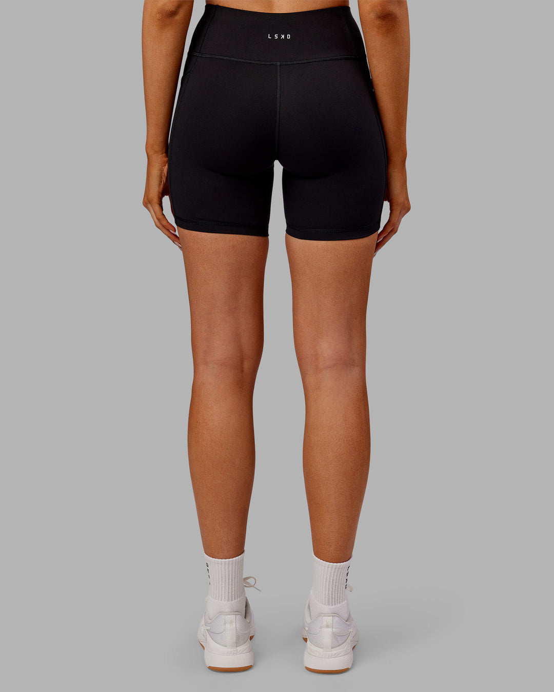 Woman wearing Rep Ultra High-Rise 6&quot; Short Pockets - Black-Ultra Orange | Model:Ella | Size:S