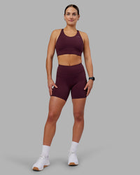 Woman wearing Rep Ultra High-Rise 6" Short Pockets - Cherry Lacquer-White | Model:Keisha | Size:S