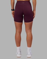 Woman wearing Rep Ultra High-Rise 6" Short Pockets - Cherry Lacquer-White | Model:Keisha | Size:S