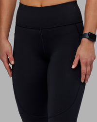 Woman wearing Rep Ultra High-Rise 7/8 Legging Pockets - Black-Scarlet | Model:Keisha | Size:S