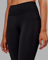 Woman wearing Rep Ultra High-Rise 7/8 Legging Pockets - Black-Ultra Orange | Model:Ella | Size:S