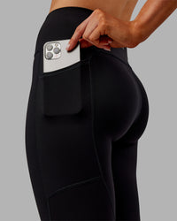 Woman wearing Rep Ultra High-Rise 7/8 Legging Pockets - Black-Ultra Orange | Model:Ella | Size:S