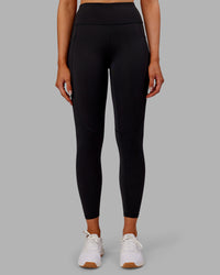 Woman wearing Rep Ultra High-Rise 7/8 Legging Pockets - Black-Ultra Orange | Model:Ella | Size:S
