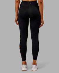 Woman wearing Rep Ultra High-Rise 7/8 Legging Pockets - Black-Ultra Orange | Model:Ella | Size:S