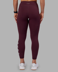 Woman wearing Rep Ultra High-Rise 7/8 Legging Pockets - Cherry Lacquer-White | Model:Keisha | Size:S