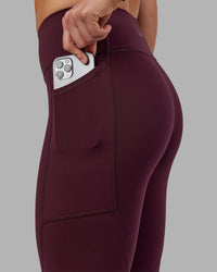 Woman wearing Rep Ultra High-Rise 7/8 Legging Pockets - Cherry Lacquer-White | Model:Keisha | Size:S