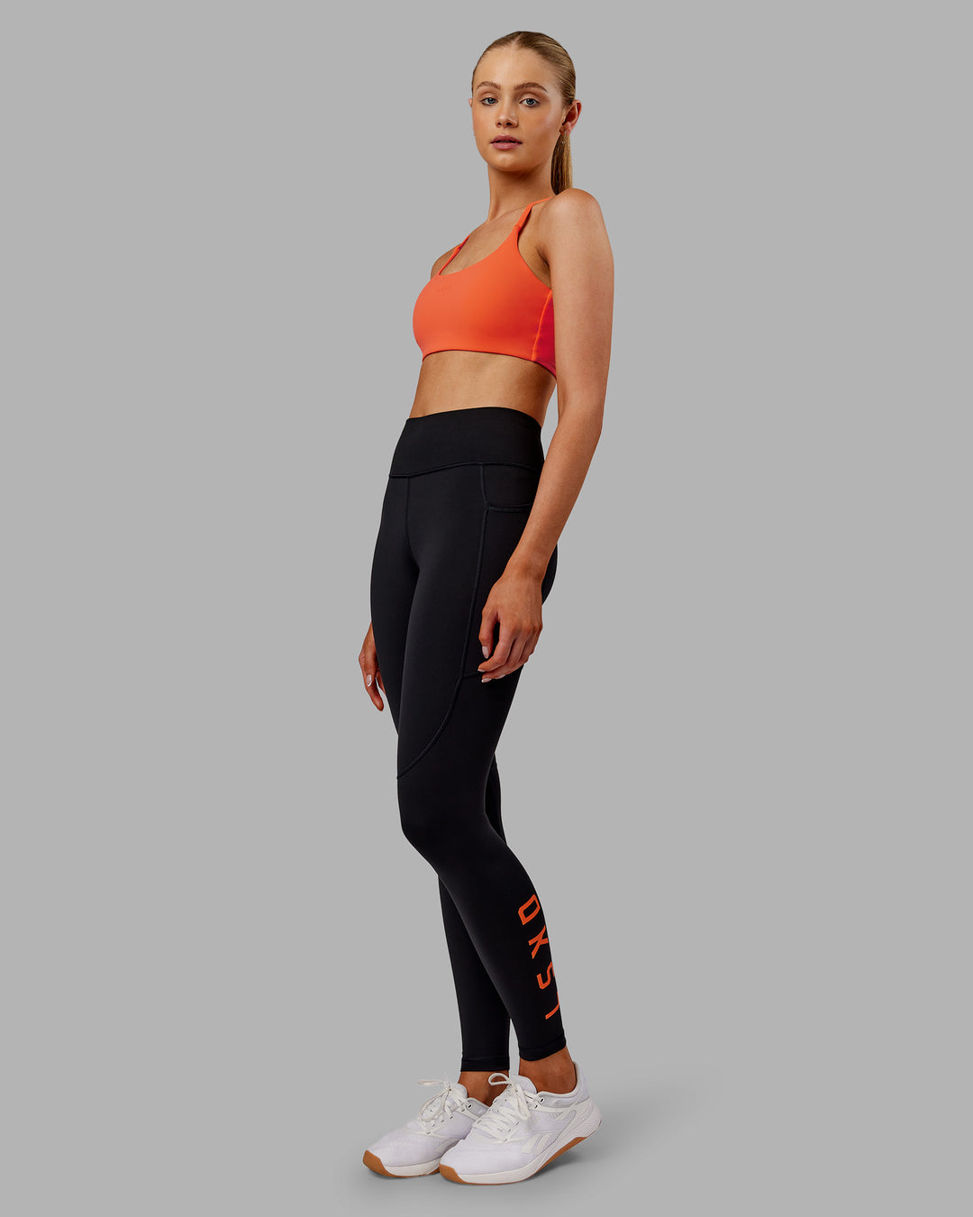 Woman wearing Rep Ultra High-Rise Full Length Legging Pockets - Black-Ultra Orange | Model:Ella | Size:S