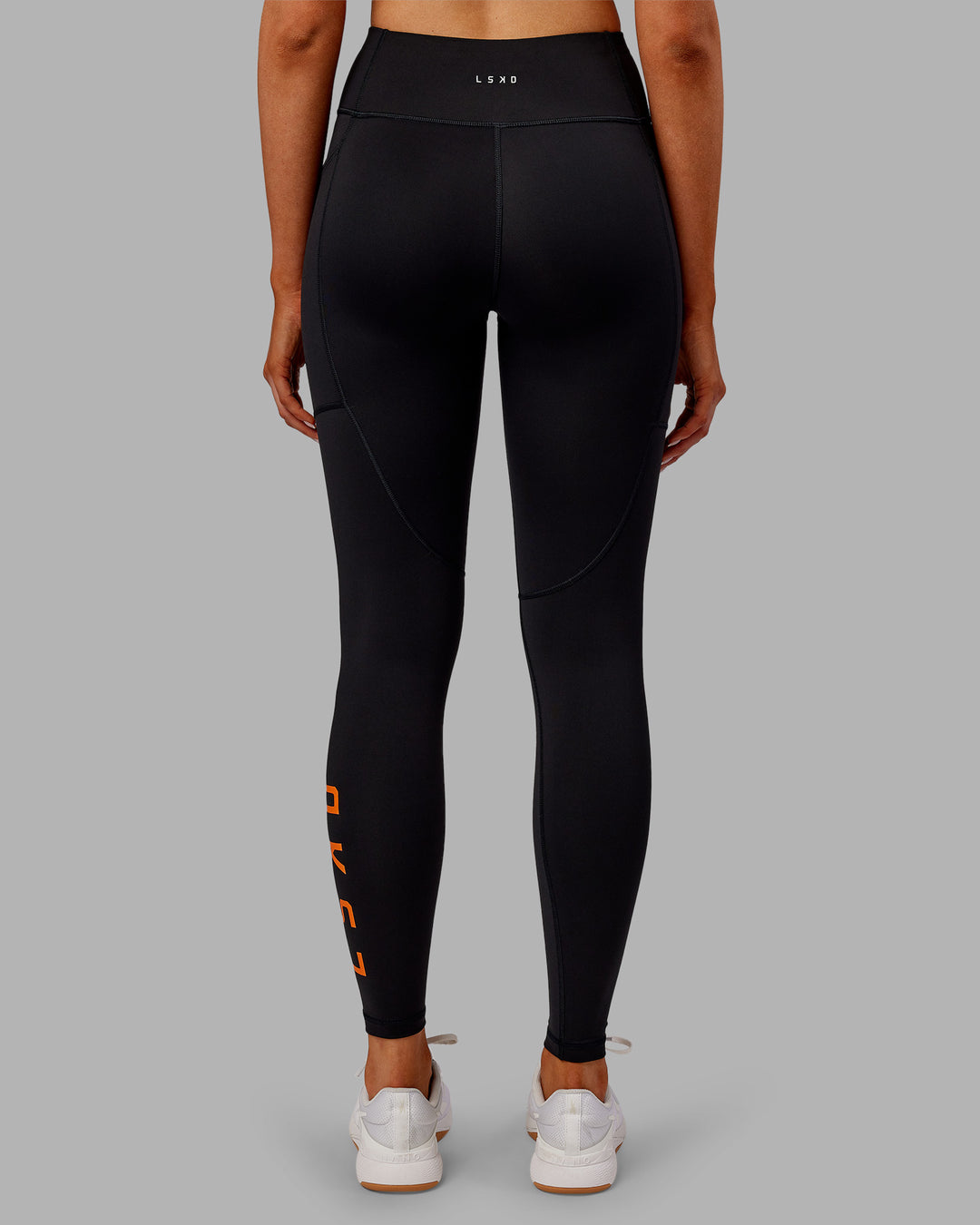 Woman wearing Rep Ultra High-Rise Full Length Legging Pockets - Black-Ultra Orange | Model:Ella | Size:S