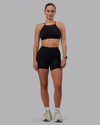 Woman wearing Rep Ultra High-Rise 4" Short Pockets - Black-Black | Model:Lillie | Size:S