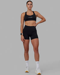 Women wearing O.G. Rep Ultra High-Rise 4" Short Pockets - Black-White | Model:Shae | Size:S
