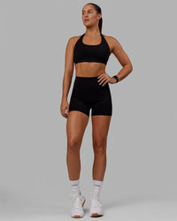 Woman wearing O.G. Rep Ultra High-Rise 4" Short Pockets - Black-Black | Model:Abbey| Size:S
