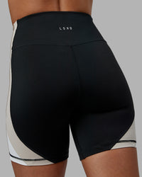 Woman wearing Revitalise Ultra High-Rise 6" Short - Black-Multi | Model:Tylah | Size:S