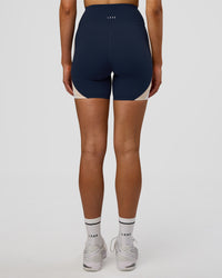 Woman wearing Revitalise Ultra High-Rise 6" Short - Future Navy-Multi | Model:Evie | Size:S