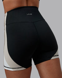 Woman wearing Revitalise Ultra High-Rise 4" Short - Black-Multi | Model:Tylah | Size:S