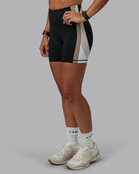 Woman wearing Revitalise Ultra High-Rise 4" Short - Black-Multi | Model:Tylah | Size:S