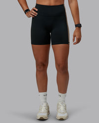 Woman wearing Revitalise Ultra High-Rise 4" Short - Black-Multi | Model:Tylah | Size:S