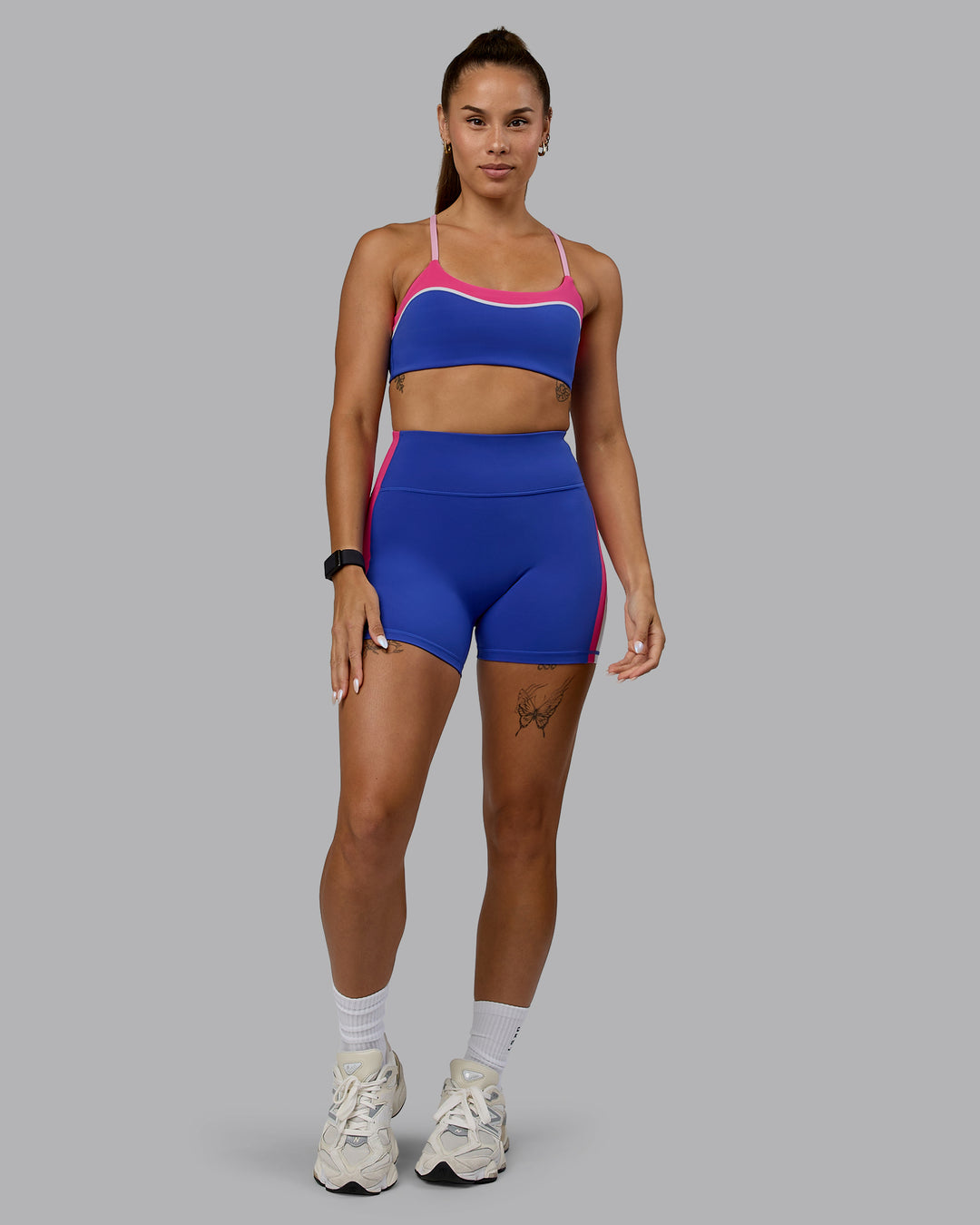 Woman wearing Revitalise Ultra High-Rise 4&quot; Short - Power Cobalt-Fuchsia Pink