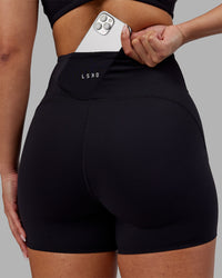 Woman wearing Rhythm Elixir Ultra High-Rise 4" Short - Black | Model:Ayla | Size:S | Thumbnail Index: 4