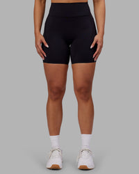 Woman wearing Rhythm Elixir Ultra High-Rise 6" Short Pockets - Black | Model:Ayla | Size:S