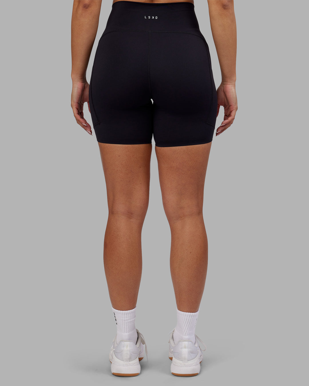 Woman wearing Rhythm Elixir Ultra High-Rise 6" Short Pockets - Black | Model:Ayla | Size:S