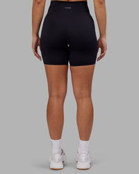 Woman wearing Rhythm Elixir Ultra High-Rise 6" Short Pockets - Black | Model:Ayla | Size:S