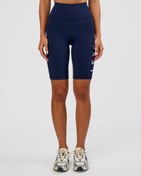 Woman wearing Rep Ultra High-Rise 9" Short Pockets - Future Navy-White | Model:Dakota | Size:S