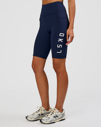 Woman wearing Rep Ultra High-Rise 9" Short Pockets - Future Navy-White | Model:Dakota | Size:S