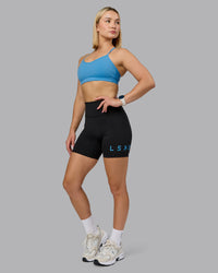 Woman wearing Rush Sports Bra - Azure Blue | Model:Halle | Size:S