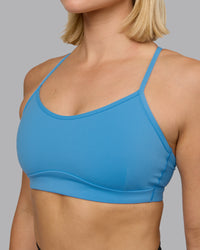 Woman wearing Rush Sports Bra - Azure Blue | Model:Halle | Size:S