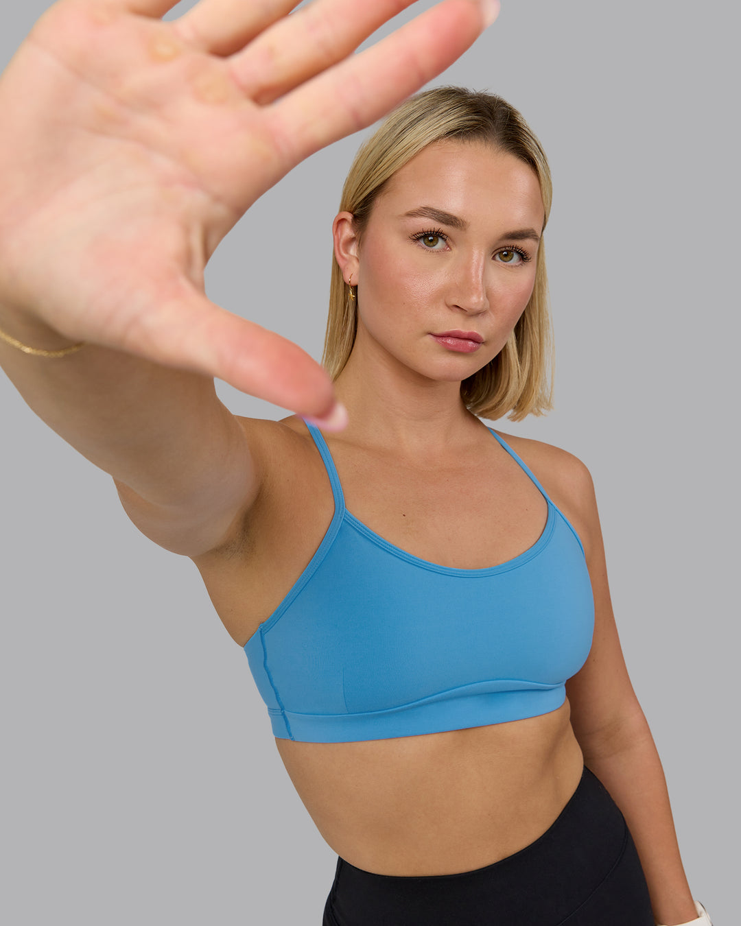 Woman wearing Rush Sports Bra - Azure Blue | Model:Halle | Size:S