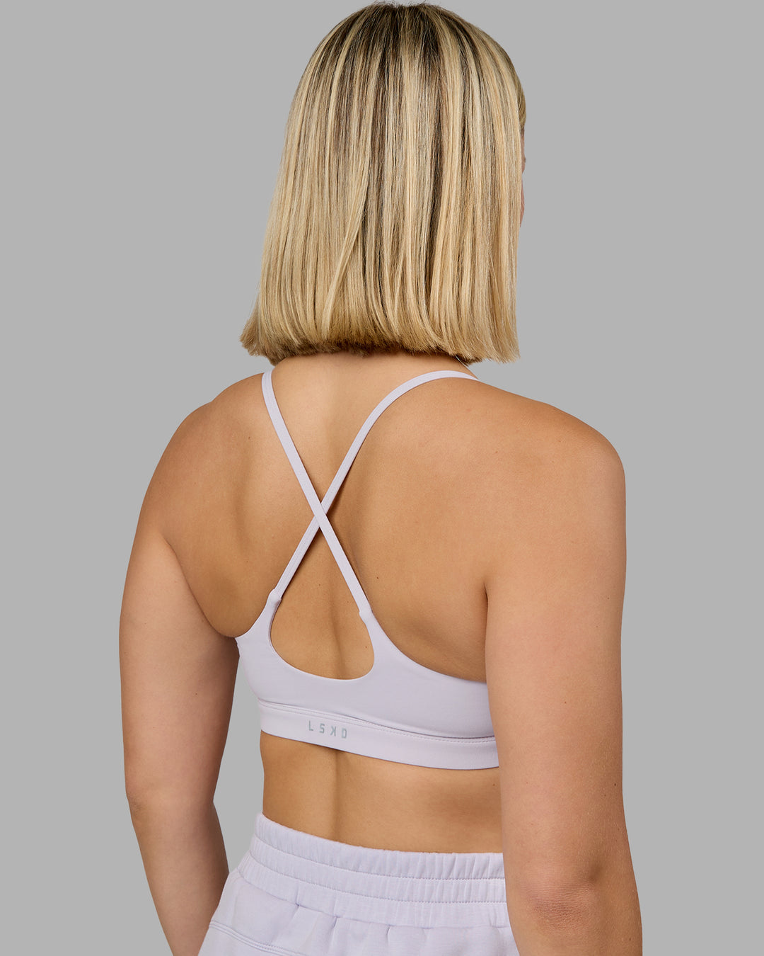 Woman wearing Rush Sports Bra - Lilac Smoke | Model:Halle | Size:S